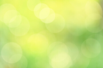 Obraz premium Bokeh Light Background,Blurry natural green leaves bokeh for Spring product background, Image defocus abstract yellow sunlight reflection texture in the morning for Summer banner or screen wallpaper