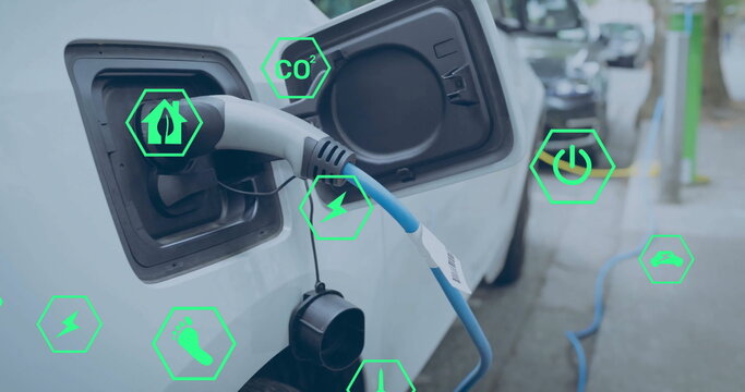 Image of eco icons over electric car being charged