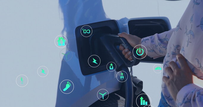 Image of eco icons over african american man charging electric car