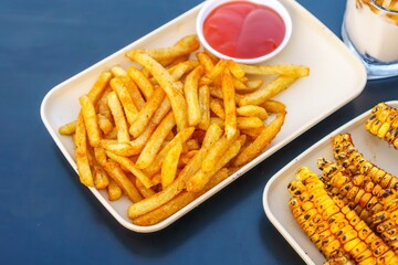 A tantalizing array of crispy, golden french fries, arranged like a work of art on a clean white rectangular plate
