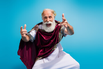 Photo of crazy cheerful man ancient god wear traditional mantle cosplay party dance isolated on...