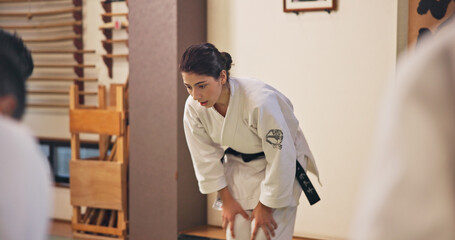 Martial arts, woman and bow with respect in dojo for honor, self defense training and discipline in...
