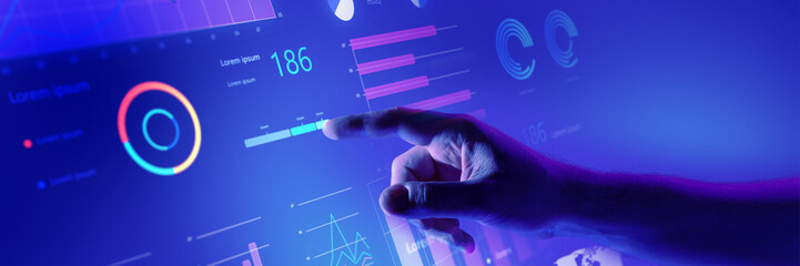 Hand interacting with comprehensive business dashboard displaying various data insights and performance graphs. Banner. Concept of business, analytics, technology, innovation. Banner