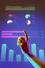 Hand pointing to dynamic and colorful graphs on futuristic digital screen. Represents data...