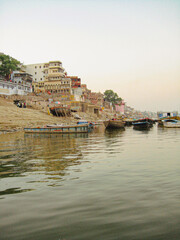 Naklejka premium Varanasi, uttar pradesh, India . Ghats at the ganges river is located in varanasi city, the banks of river ganges as seen from a boat on river ganges.Uttar pradesh state, north India. 