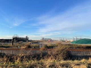 Industrial Landscape with Railway Tracks and Port Infrastructure under Clear Blue Sky