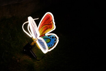 A beautifully illuminated butterfly sculpture featuring vibrant colors, perfect for adding charm to...