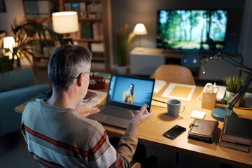 Man videocalling a woman on his laptop