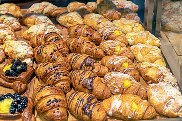 craft croissants with different fillings on the counter in the supermarket. seed bakery