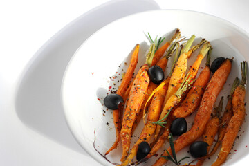 Just Harvested Fresh Carrots Roasted in Oven with Olive Oil, Salt and Pepper, Garnished with...