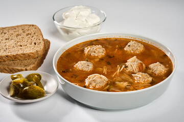 Meatball soup with bread, cream and jalapeno
