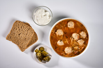 Meatball soup with bread, cream and jalapeno