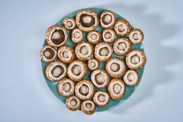 Brown champignon mushrooms on white