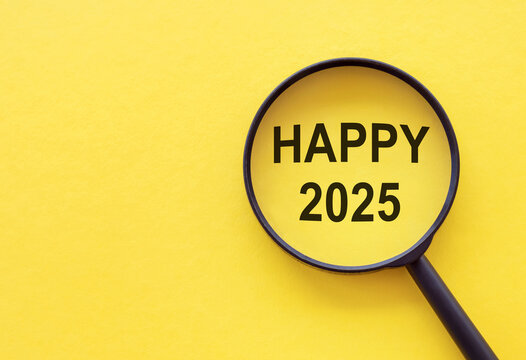A magnifying glass highlights the message of happiness for the upcoming New Year 2025 against a vibrant yellow background.
