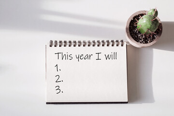 New Year's Resolution Planning for 2025 With a Notebook and Cactus on a Clean Desk