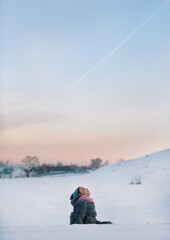 the girl saw a flying plane and looks at it joyfully