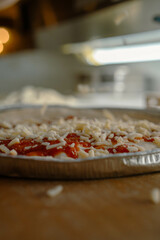 A side-angle view of a fully topped pizza on a tray showcases its texture and freshness.