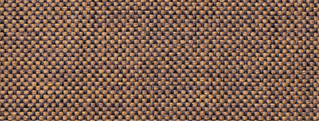 Texture dark brown background from woven textile with wicker pattern, macro. Structure vintage umber fabric