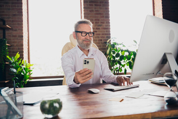 Photo of senior nice man specialist financier economist dressed shirt working modern gadget indoors workstation