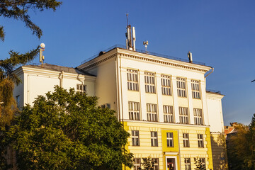 An elegant building in Irkutsk with classic architecture and ornate facade illuminated by autumn sunlight. Irkutsk city, historical building.