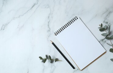 Business concept. Top view photo of workplace with planner, penсil, eucalyptus on marble...