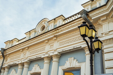 Obraz premium Building with Columns and large windows under an autumn sky. Irkutsk city, downtown historical building.