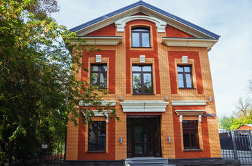 Beautiful brick facade of a building in Irkutsk, showcasing architectural style amidst autumn colors.