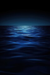 Serene ocean waves reflect a deep blue hue, creating a tranquil and mesmerizing seascape at dusk.