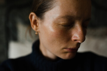 Obraz premium Young beautiful woman without make up with sad mood in dark room. Depression.