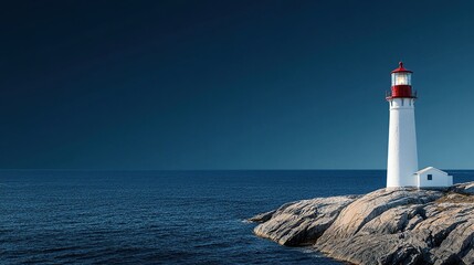 Fototapeta premium A serene lighthouse stands on rocky shores under a dark blue sky, guiding ships safely.