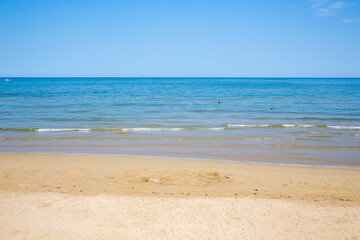 Gargano beach, tourist destination in Puglia, Italy. There are people on vacation and in the water.
