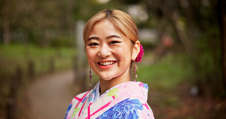 Happy, nature and portrait of Japanese woman outdoor with traditional kimono for fashion. Smile, confident and female person with cultural colorful dress for stylish outfit in park for calm and peace