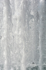 A close-up of a fountain, showcasing a mass of white, frothy water gushing upwards in dynamic motion