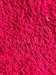 close up of red terry towel texture for background. Top view.