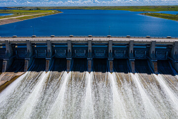 A large body of water with a dam and a bridge over it