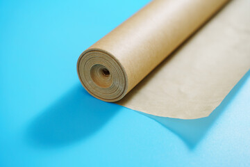 A roll of baking paper on a blue background. tools for baking at home.