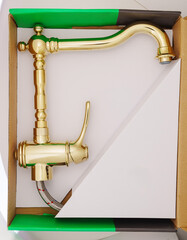 New gold retro style faucet for the sink in the box. Stylish elements for a beautiful, classic...
