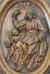 ANNECY, FRANCE - JULY 10, 2022: The carved relief of St. Matthew the Evangelist in the St. Maurice...