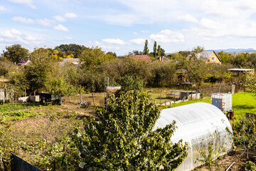 Fototapeta premium country vegetable garden with hothouse in autumn