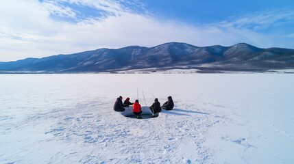 group of friends ice fishing on a frozen lake, sitting around a hole in the ice, with a snowy mountain