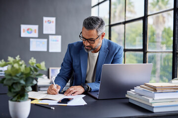 Mature busy businessman working at desk
