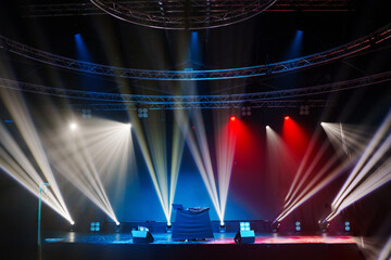 a concert stage with beams from spotlights. Professional decoration and lighting for events.