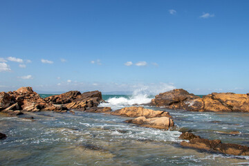 Fototapeta premium Deserted Haven: Ain Kanassira's Beach Nestled Between Sea and Mountains in Tunisia