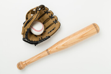 Baseball glove and bat with ball on color background, top view