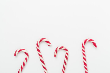 Minimal composition with christmas lollipops on color background, top view