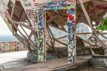 Graffiti on old radio station teufelsberg in Berlin with the view of the Berlin City.