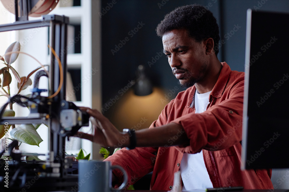Fototapete man performing intricate work with a 3d printer, highlighting concentration and precision. the works