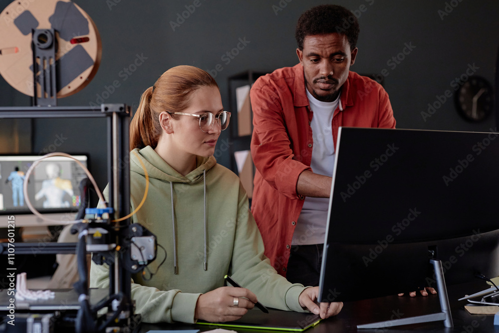 Leinwandbilder two colleagues collaborating on project in modern workspace, involving 3d printing and computer work