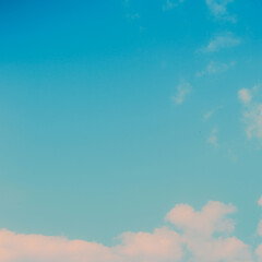 A beautiful blue sky with a few white clouds on a bright summer day creates a heavenly backdrop.