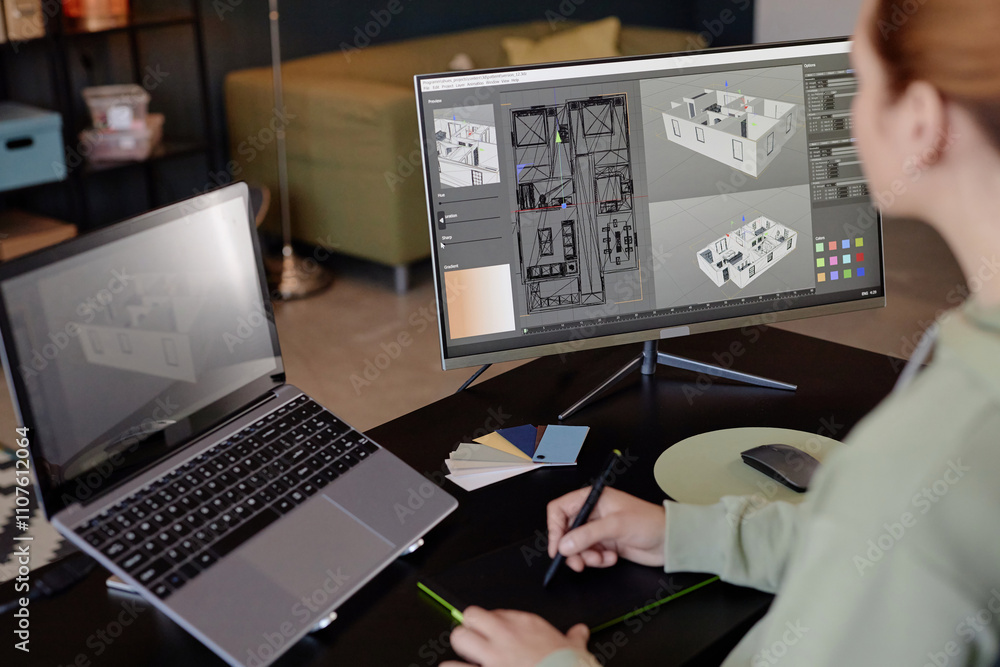 Fototapete Individual engrossed in creating detailed architectural design on computer using modern digital tools, with another laptop on side for reference and color samples laying on desk
